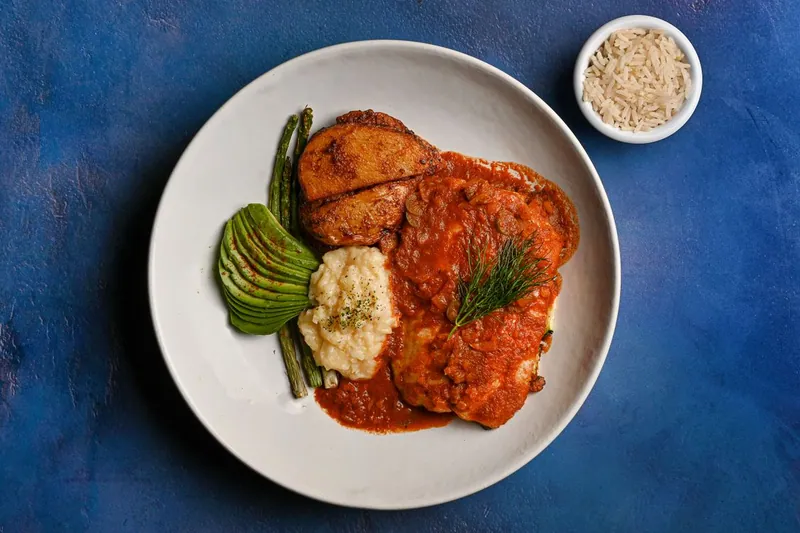 Sauced chicken served with asparagus and potatoes