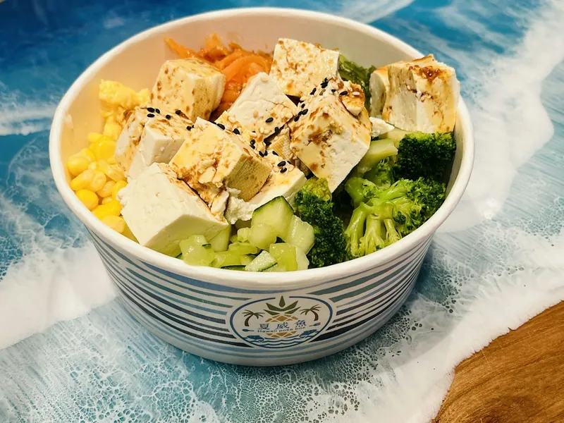 Tofu broccoli corn and vegetable bowl with sesame dressing