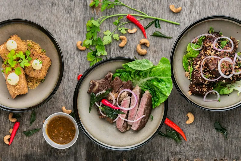 A table filled with several colorful dinner dishes