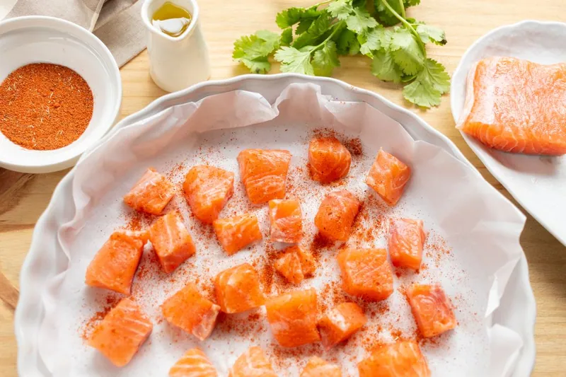 Seasoned salmon cubes ready for the air fryer