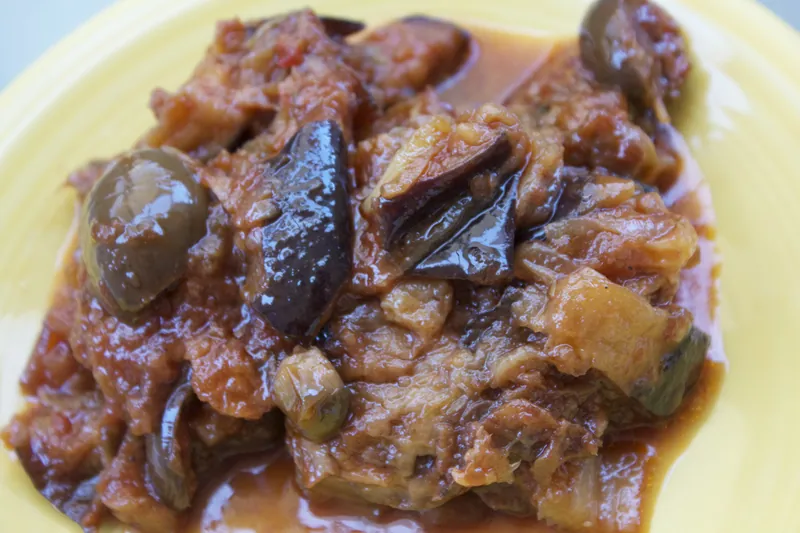 Sicilian caponata with glossy eggplant chunks, tomatoes, green olives and capers