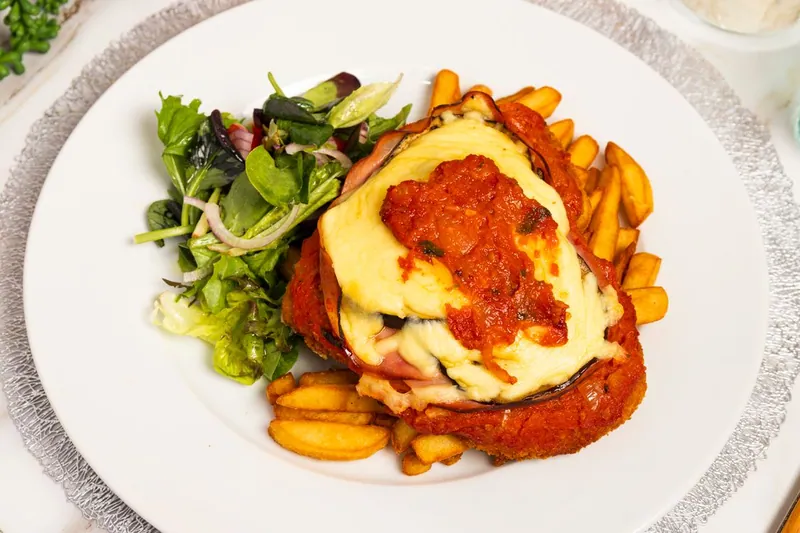 Breaded chicken Parmesan with tomato sauce and melted cheese