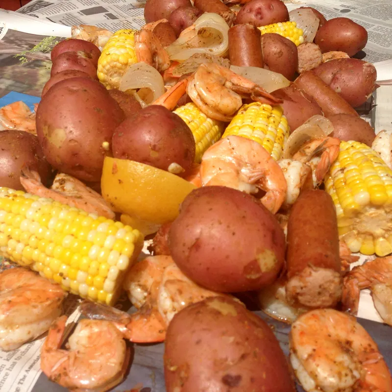 Lowcountry shrimp boil with pink shrimp, red potatoes, yellow corn and sliced smoked sausage