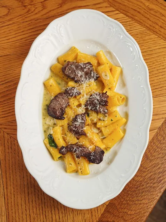 Seared beef strips with pasta in a creamy Parmesan sauce
