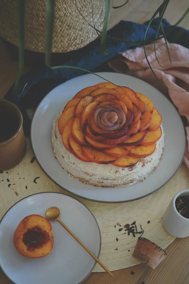 Slices of golden summer peach cake served on a white plate