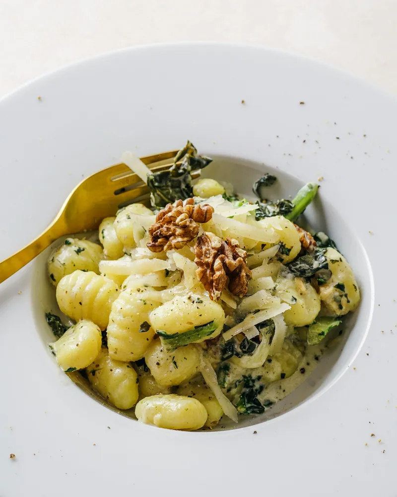 Brown butter gnocchi with kale walnuts Parmesan and sage