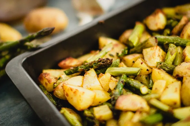 Roasted potatoes and asparagus on a rimmed sheet pan