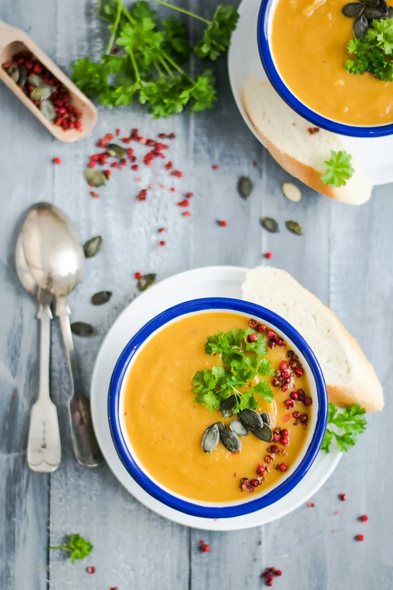 Creamy orange sweet potato soup with herbs and pepitas