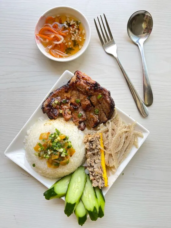 Glazed pork chop served with rice and crisp shredded vegetables