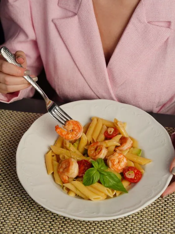 Shrimp pasta with tomatoes, basil, and a glossy sauce